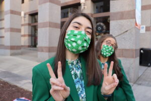 two state 4-H officers with their 4-H masks on, one making a funny face
