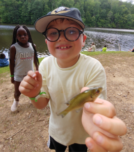 child holding a small fish