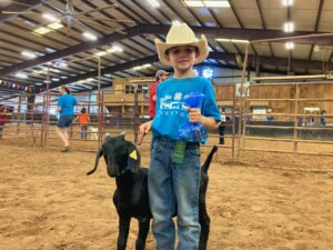 4-H'er proudly displaying his goat at the Yadkin County Livestock Show